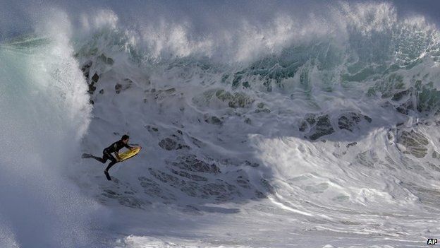 A bogieboarder rides a wave at the wedge in Newport Beach, California 27 August 2014