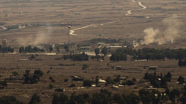 Smoke rises from the Syrian Golan Heights during clashes between Syrian rebels and government forces on 28 August 2014