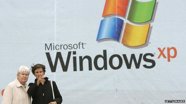 Women in front of Windows XP poster