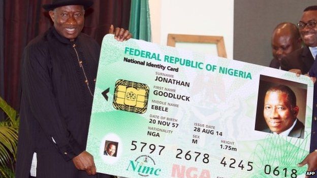 Nigerian President Goodluck Jonathan holds a replica of his electronic identity card - 28 August 2014