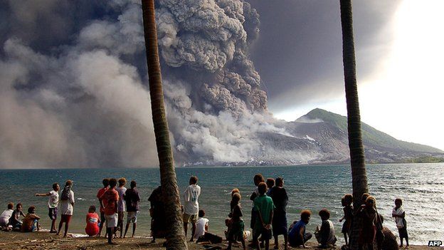 A file photo taken on 7 October, 2006, shows evacuated Matapit Islanders watching Mt Tavurvur volcano erupt sending ash and rocks over the already devastated city of Rabaul on New Britain Island in Papua New Guinea