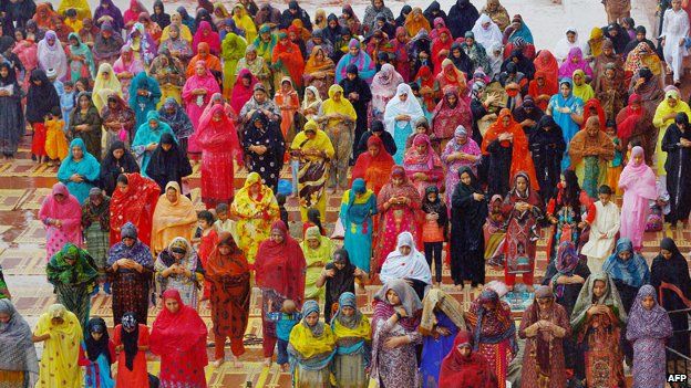 Women wearing colourful headscarves during Eid in Pakistan