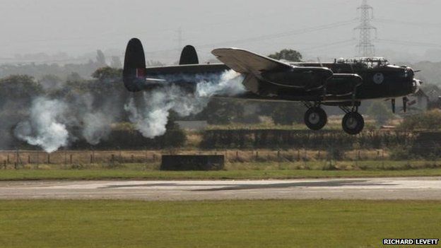 Lancaster bomber mid-air engine fire - BBC News