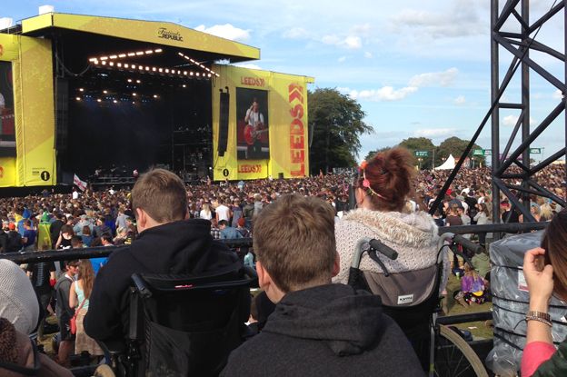 Disabled people sit on a raised viewing platform at the Leeds festival