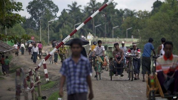 People pass through a security checkpoint in Maungdaw, northern Rakhine state, Myanmar - 14 September 2013