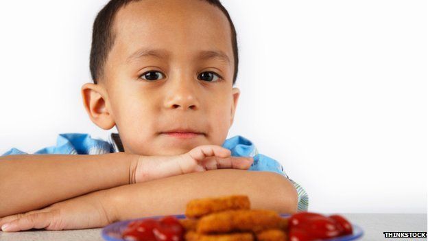 Child with chicken nuggets