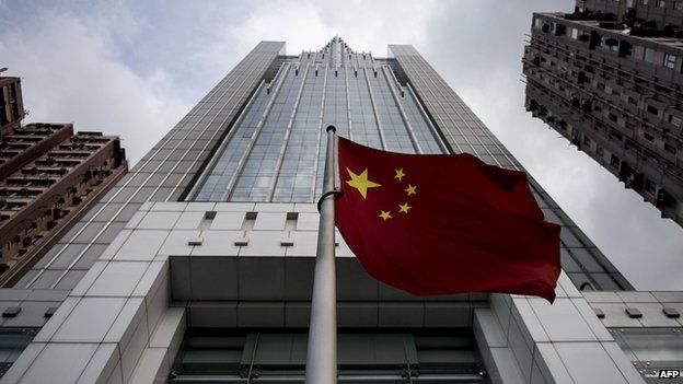 The Chinese national flag flies in front of the Liaison Office of the Central People"s Government in Hong Kong on August 27