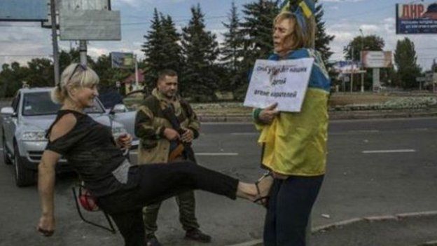 Iryna Dovgan is being kicked by a woman in Donetsk