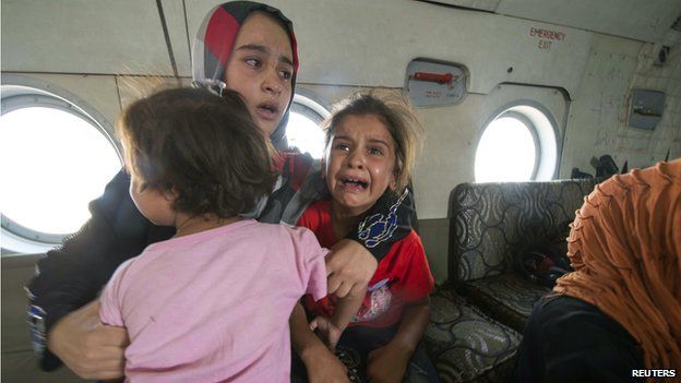 A woman and children in an Iraqi military helicopter evacuated from Amerli on August 29 2014
