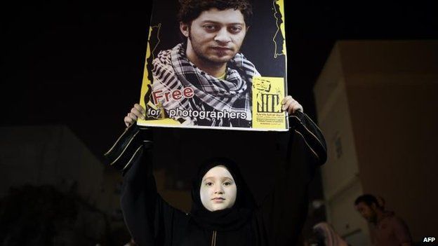 A Bahraini girl holds up a portrait of Ahmed Humaidan during a protest in Sitra, 30 August