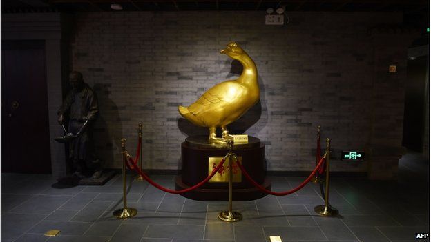 This photo taken on 24 July 2014 shows a golden duck in the museum at the Quanjude restaurant in Beijing