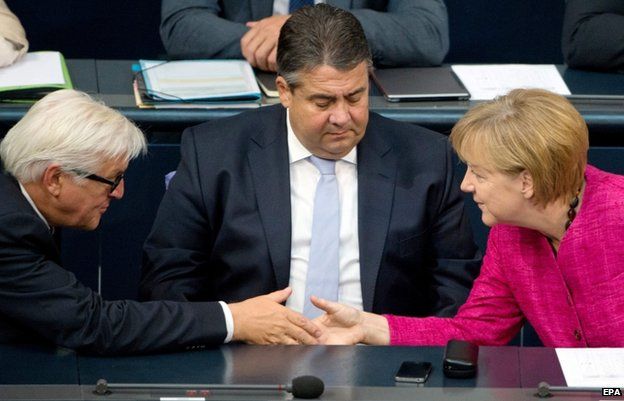 Chancellor Angela Merkel with Sigmar Gabriel (C) and Frank-Walter Steinmeier (L) of the centre-left SPD