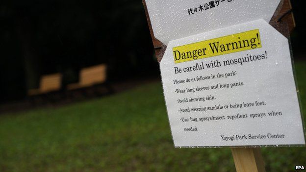 A board warns visitors about mosquitoes at Yoyogi Park in central Tokyo, Japan, on 1 September 2014
