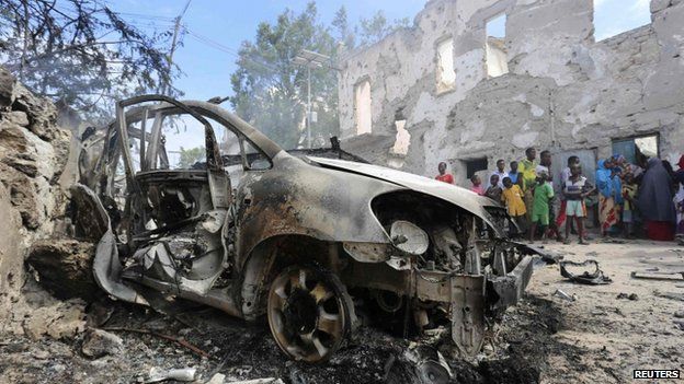 A destroyed car after an attack by suspected militants at the Jilacow underground cell inside a national security compound in Mogadishu (31 August 2014)
