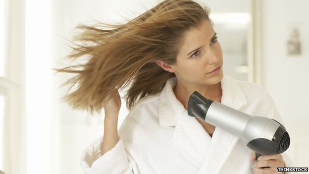 Woman and hairdryer
