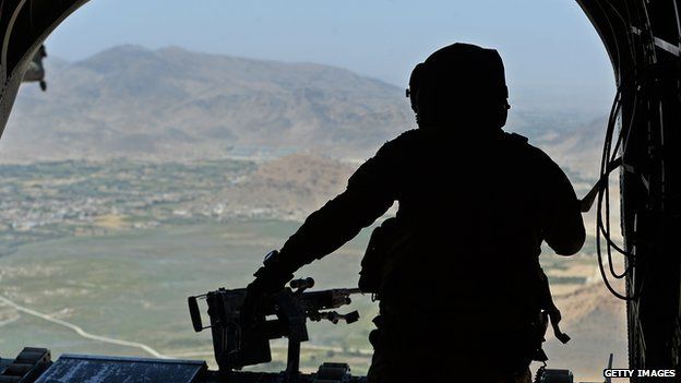 US soldier, part of the NATO-led International Security Assistance Force (ISAF), manning a machine gun onboard a Chinook helicopter over the Gardez district of Paktia province on 11 August 2014