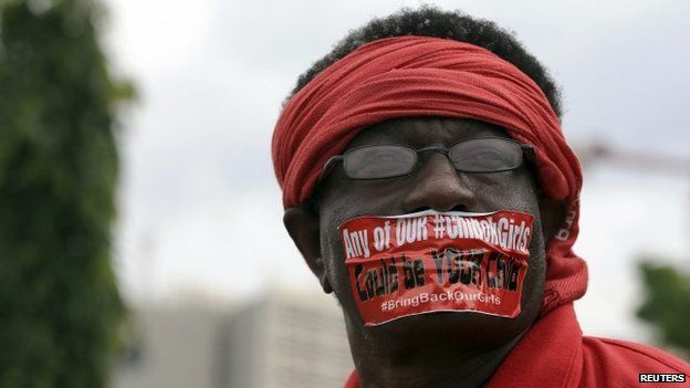 A demonstrator looks on during a rally that was held to mark the 120th day since the abduction of two hundred school girls by the Boko Haram, in Abuja (12 August 2014)