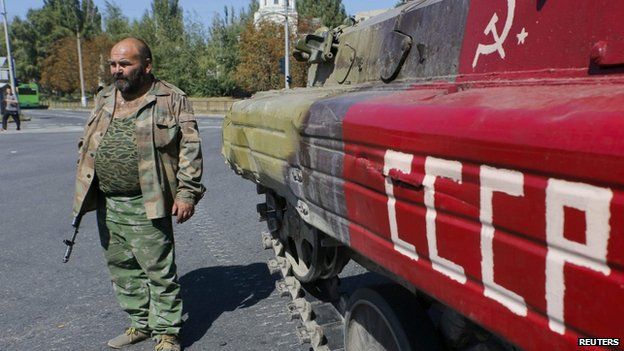 Pro-Russian rebel in Donetsk with armoured vehicle with USSR written on side