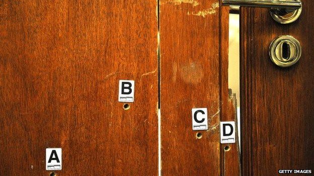 Bullet holes in Oscar Pistorius' toilet door