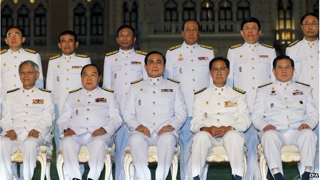 Thai military junta chief and newly appointed Prime Minister General Prayuth Chan-ocha (centre, seated) and unidentified cabinet members pose for a group photo after a swearing-in ceremony at the Government House in Bangkok, Thailand, 4 September 2014.
