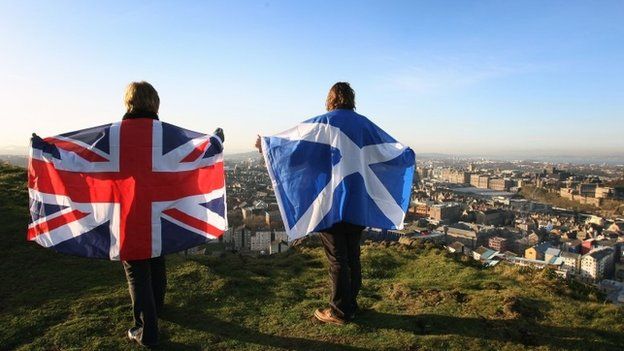 Scottish and UK flags held up over Edinburgh