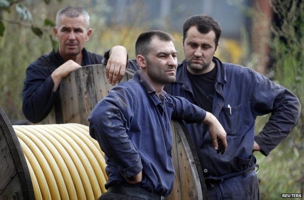 Miners stand outside the Raspotocje coal mine in Zenica, 5 September