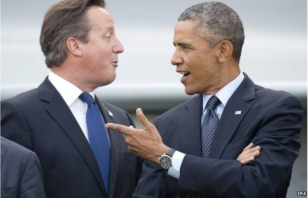 US President Barack Obama (right) and British Prime Minister David Cameron comment on the NATO flypast on day two of the 2014 NATO summit at the Celtic Manor Resort in Newport, south Wales 5 September