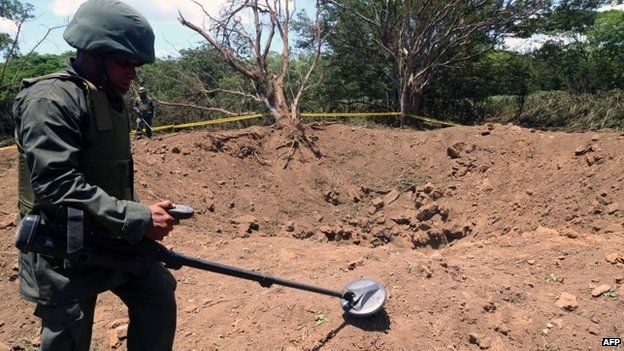 A Nicaraguan soldier checks the site where a meteorite struck on 7 September, 2014 in Managua.