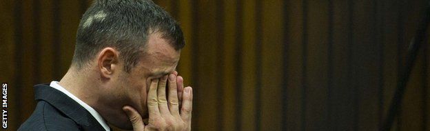 Pistorious wipes tears from his eyes during the trial