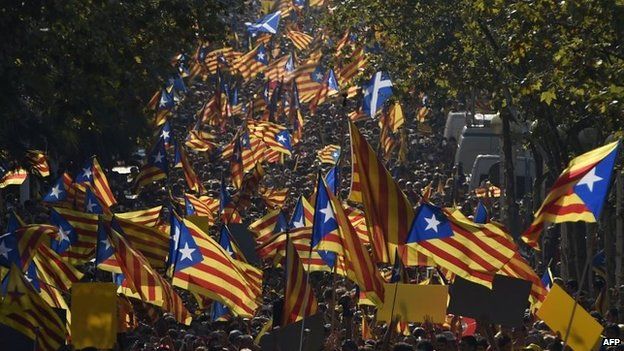 Catalans hold Catalonia pro-independence flags during celebrations of Catalonia National Day (Diada) in Barcelona on 11 September 2014