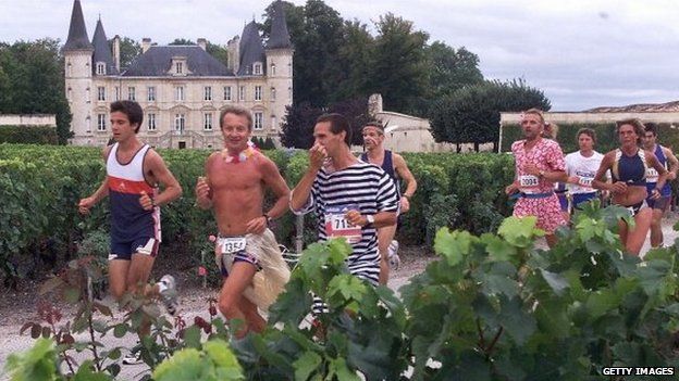 Participants run past Chateau Pichon-Longueville and its vineyards by Pauillac