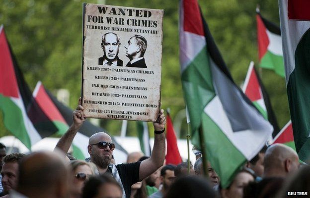 A man holds a placard during a demonstration in support of Palestinians in Berlin - 1 August 2014