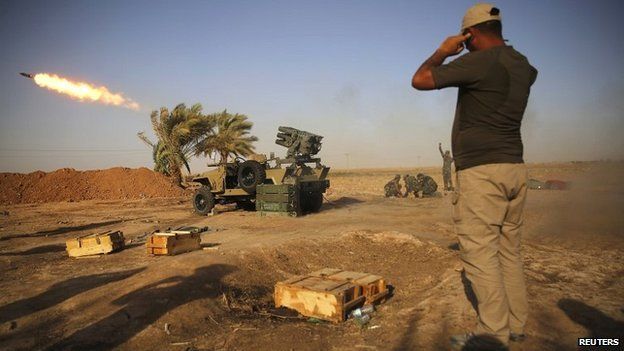 Members of a Shia militia launch rockets towards Islamic State fighters during heavy fighting near Tikrit in northern Iraq - 12 September 2014