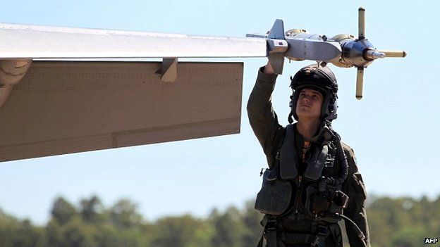 A member of Australia's Air Force carries out checks on a Super Hornet fighter jet - 11 August 2014
