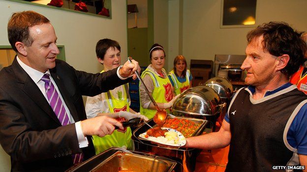 New Zealand Prime Minister John Key serves dinner to volunteers following the Christchurch earthquake on 7 September, 2010
