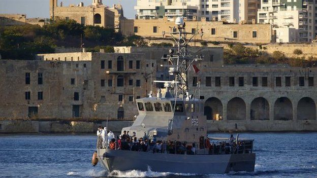An Armed Forces of Malta (AFM) patrol boat carrying rescued migrants approaches the AFM"s Maritime Squadron base at Haywharf in Valletta"s Marsamxett Harbour, August 28