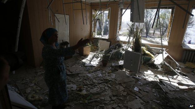A woman shows the damage caused to a hospital in the village of Novosvitlivka, eastern Ukraine. Photo: 15 September 2014