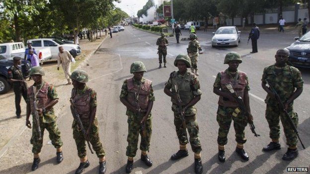 Nigerian soldiers cordon off a road leading to the scene of a blast at a business district in Abuja (June 2014)