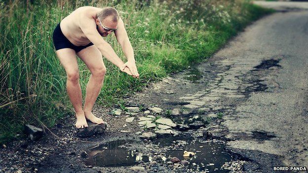 Man pretending to dive in a pothole