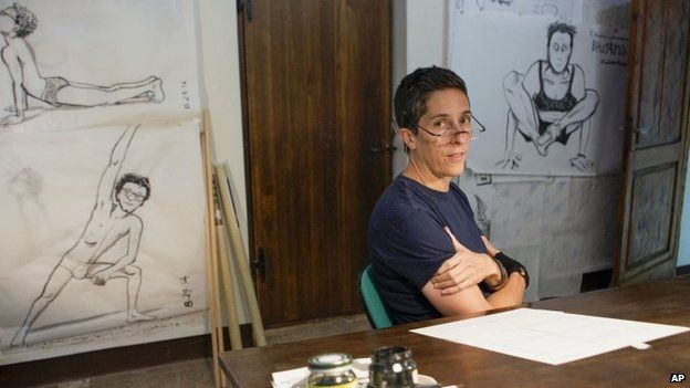 Cartoonist and graphic memoirist Alison Bechdel poses in her studio at the castle of Civitella Ranieri in central Italy 2 September 2014