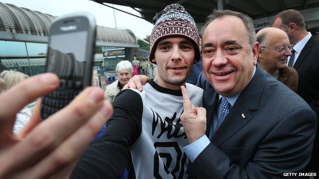 Alex Salmond poses for a photograph with a voter on the campaign trail