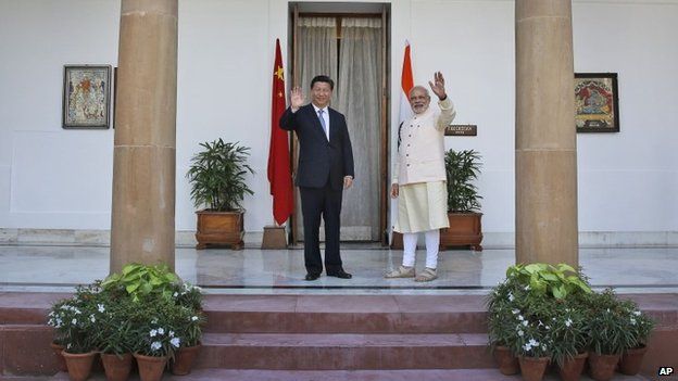 Indian Prime Minister Narendra Modi and visiting Chinese President Xi Jinping wave to the media before a meeting in New Delhi, India, Thursday, Sept. 18, 2014.