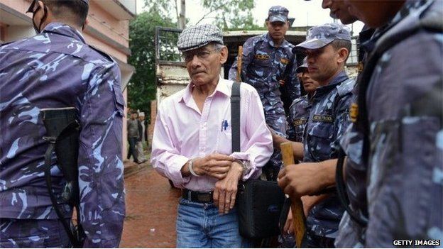 File pic of French serial killer Charles Sobhraj (C) at district court hearing