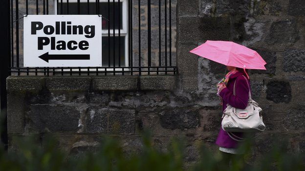 A voter arrives to cast her ballot at the Queen's Cross parish church in Aberdeen, Scotland