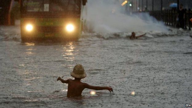 A Filipino child plays in floodwater in Manila (19 Sept 2014)