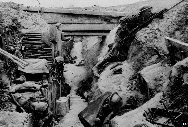A British Grenadier Guardsman keeps watch on 'No-Man's land' as his comrades sleep in a captured German trench at Ovillers during the Battle of the Somme in 1916