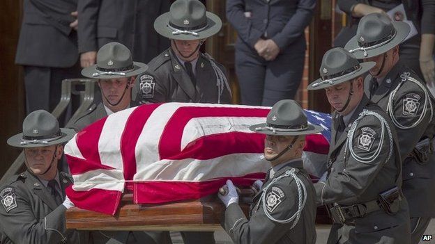 Pennsylvania State Troopers carry the casket of murdered Pennsylvania State Trooper Cpl. Bryon Dickson out of Saint Peter's Cathedral in Scranton, Pennsylvania after his funeral 18 September 2014