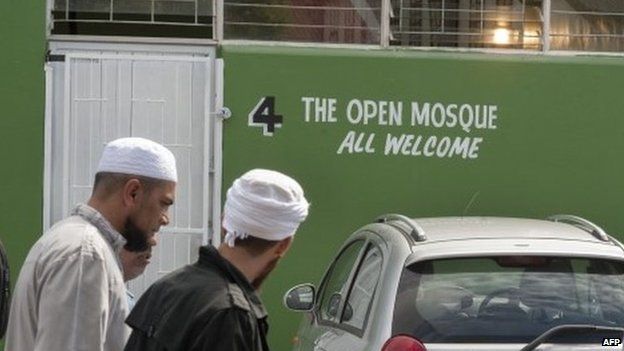 Muslims walk near the entrance of the Open Mosque, on its opening day, on September 19, 2014 in Wynberg, Cape Town.