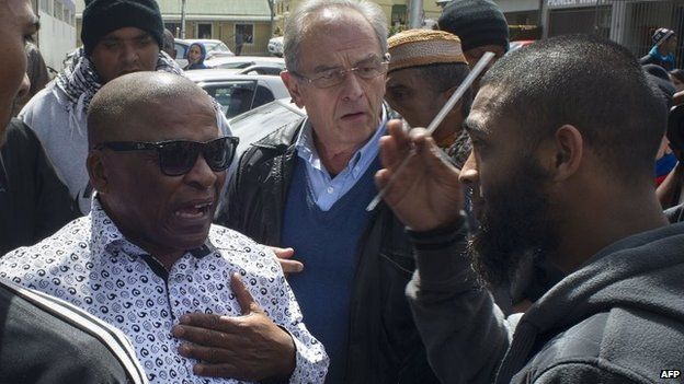 A Muslim man (R) argues with people going to the opening of the Open Mosque, on September 19, 2014 in Wynberg, Cape Town.