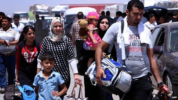Iraqis flee Mosul after IS seize city. 10 June 2014